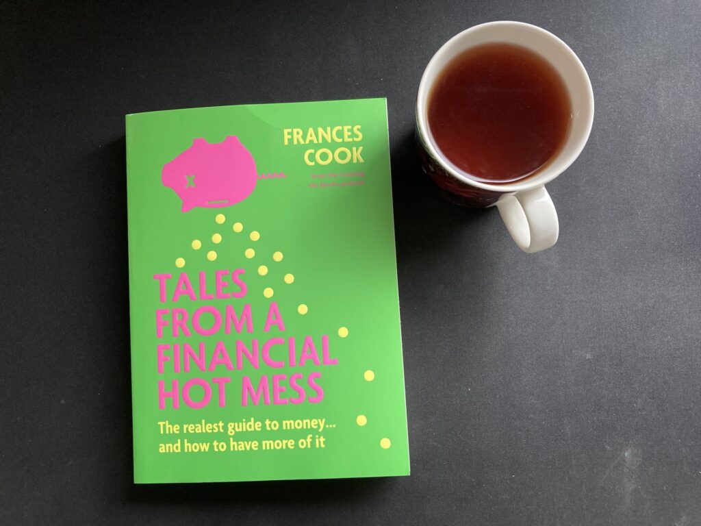 Front cover of Tales Of A Financial Hot Mess with a cup of tea next to it