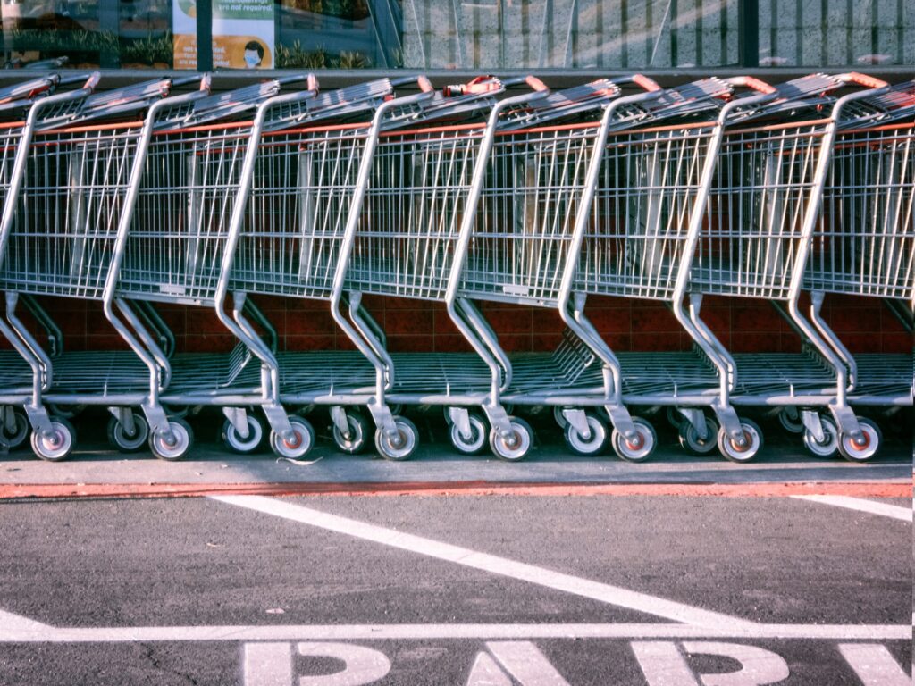 Row pf supermarket trolleys in a parking lot. Grocery prices have been going higher and higher 