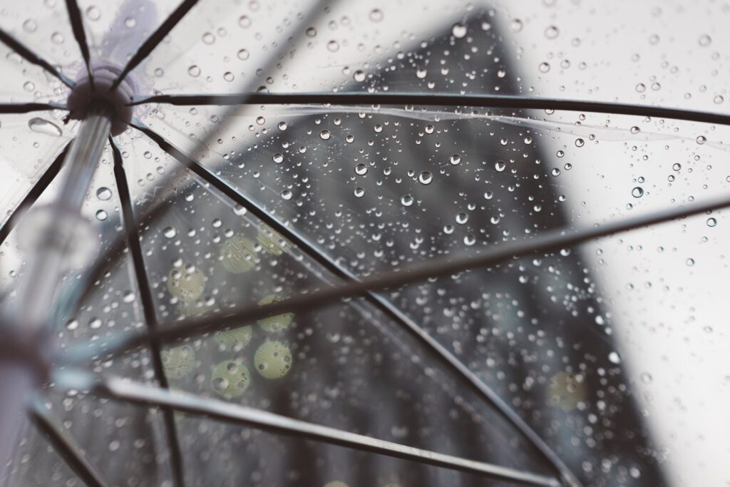 Clear umbrella with raindrops on it. Emergency fund is a great financial goal
